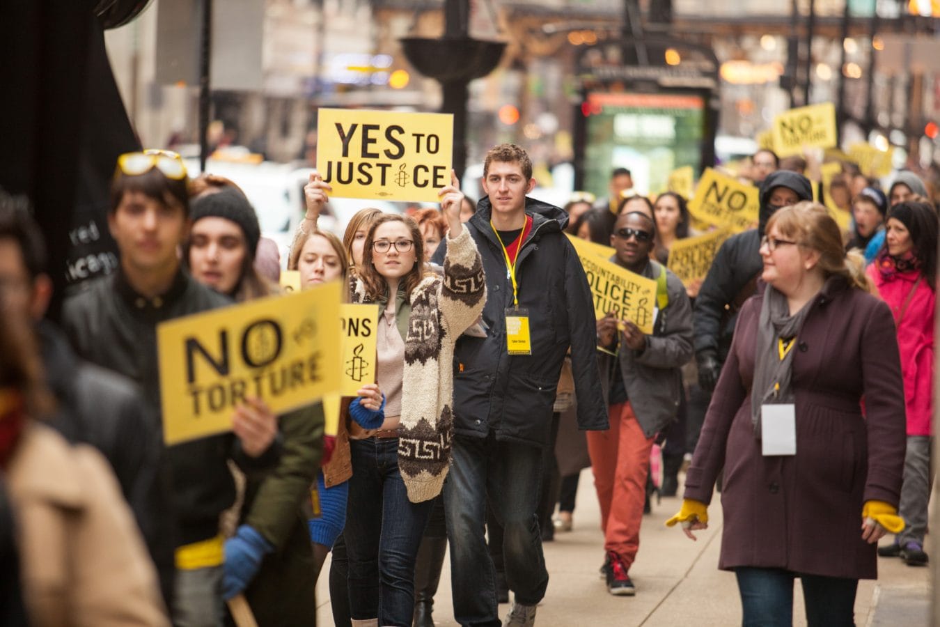Activists march with Chicago torture survivors at Amnesty International USA's 2014 human rights conference in Chicago, Illinois